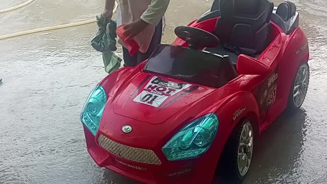 kids playing his car and clean it.