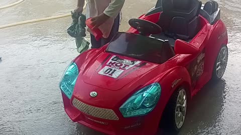 kids playing his car and clean it.