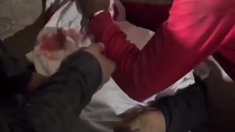 A man weeping over his brother’s body who was killed by an Israeli strike