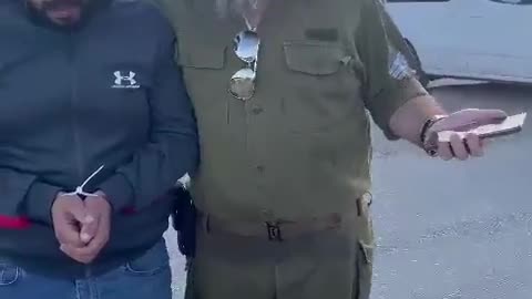 Israeli terrorist officer mocks a captured & blindfolded Palestinian