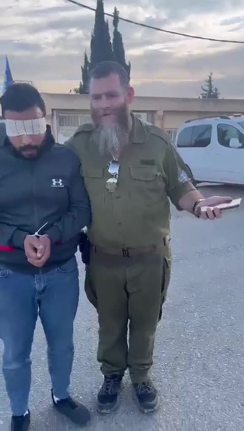 Israeli terrorist officer mocks a captured & blindfolded Palestinian