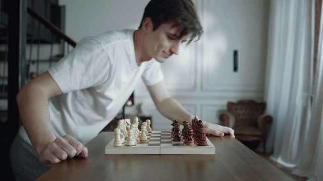 A Man Playing Chess Game Alone Changing Sides Every Move Made