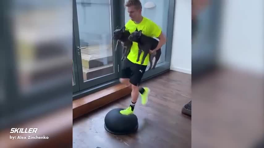 messy playing footbal with dog