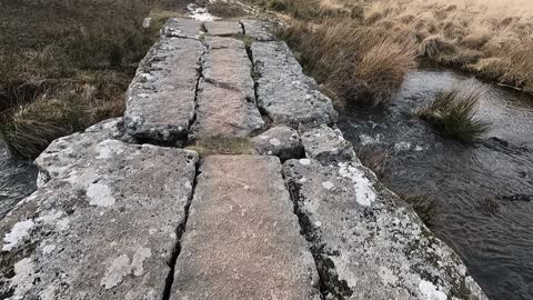 Stepping over a clapper bridge. Hiking. Gopro on a chest mount. Dartmoor.