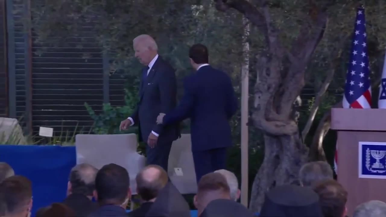 Joe Biden Being Led Off Stage After His Speech in Israel