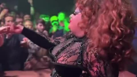 Drag Queen Spins and Dances on Stage with Full Crowd