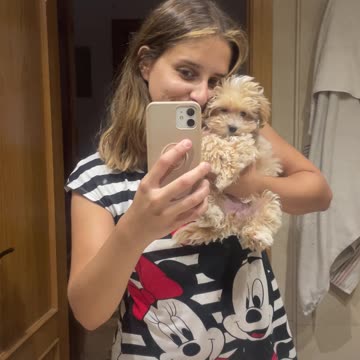 Maltipoo puppy with her owner