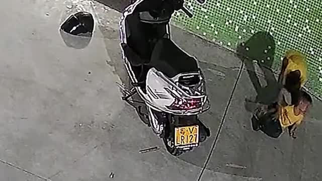 Chinese boys lift scooter up to free trapped brother #shorts