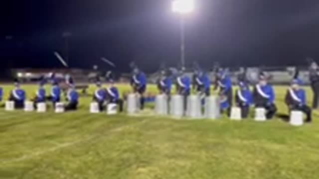 Childerburg High School drum line preforming on buckets and garage cans