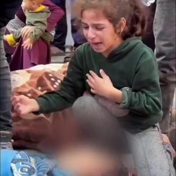 A little girl bids farewell to her little brother in Gaza