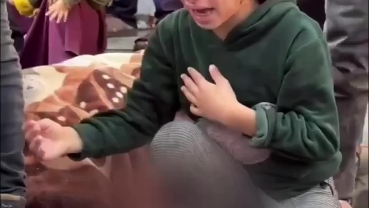 A little girl bids farewell to her little brother in Gaza