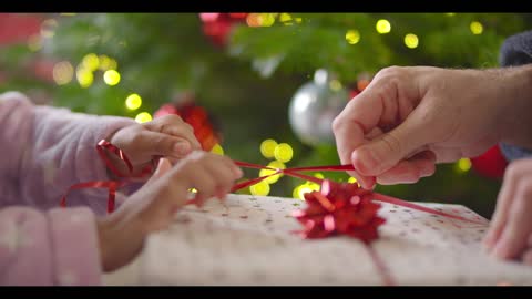 Closeup of Hands Unwrapping Present