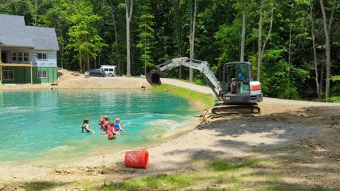 Man Uses Excavator to Create Makeshift Water Park for Kids