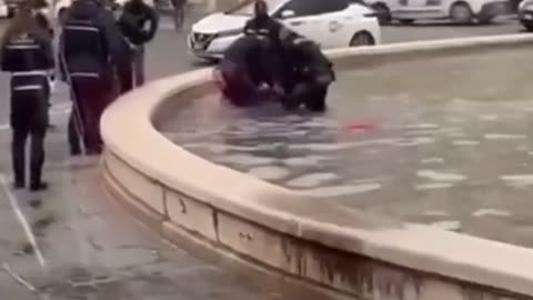 Dirty migrant takes a bath in Italy in public fountain while he splashes cops with water in defiance