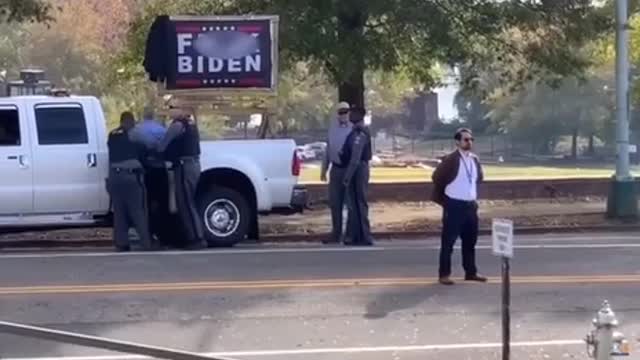 Man ARRESTED after trying to COVER UP "F*ck Joe Biden" sign