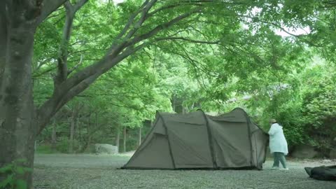 Single person outdoor exquisite camping, busy with a delicious dinner only for nightfall during the