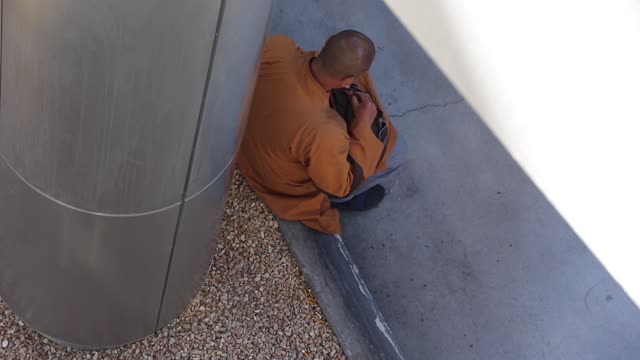 A Buddhist monk praying on the Las Vegas strip.