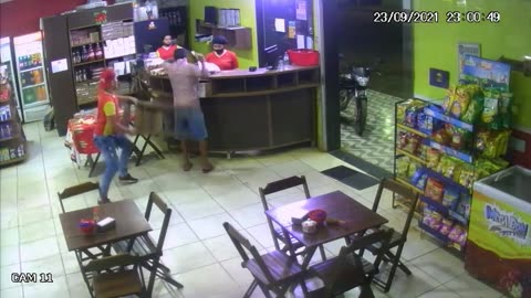 Employee gives a chair to a robber in Brazil