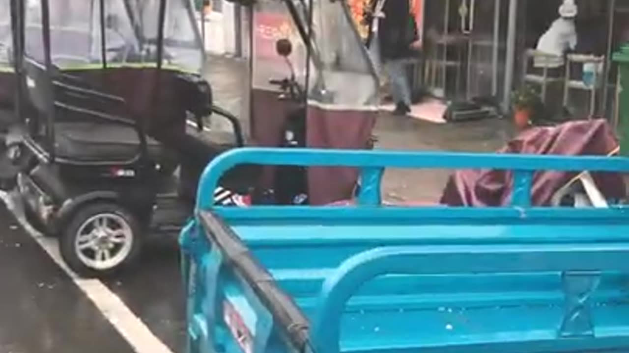 Rainy day in Henan, on a food street (where you buy lunch and other food)