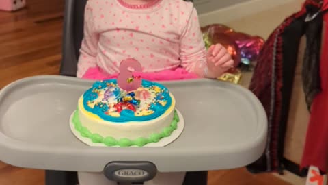 Josie blows out candle at 3rd Birthday