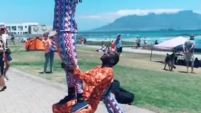 Group Of People Show Amazing Balance Skills While Performing Acro Yoga