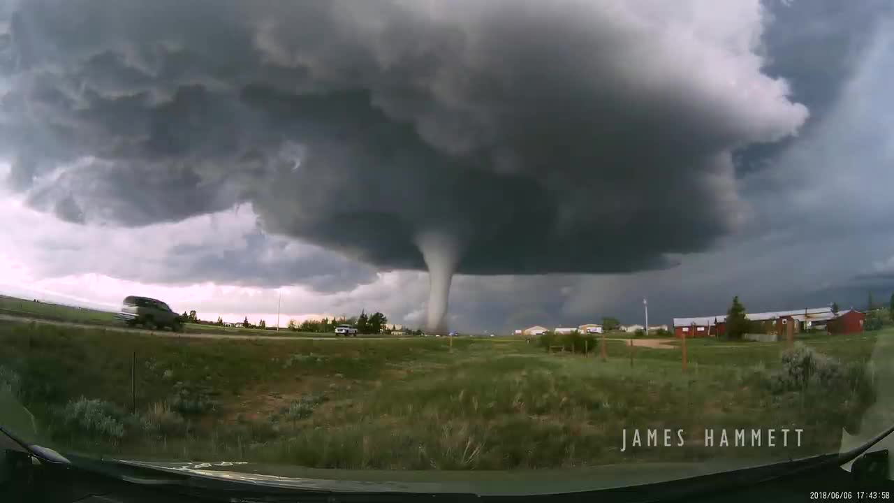 Storm chasing dashcam: Tornado crossing the highway! Laramie, Wyoming