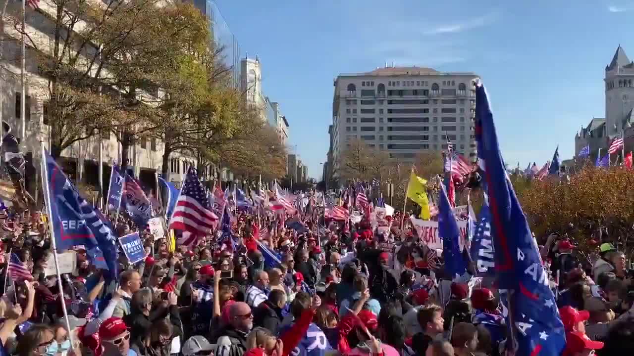 Thousands of Trump supporters sing the “Star Spangled Banner” in unison.