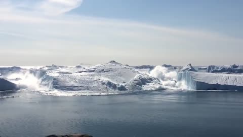 Ilulissat Icefjord - Large iceberg breaking over