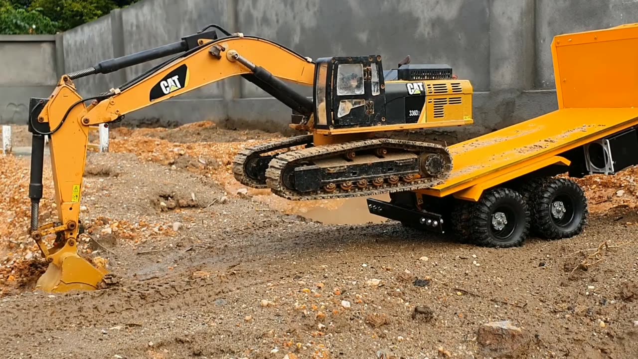 RC Excavator getting off yellow trailer truck