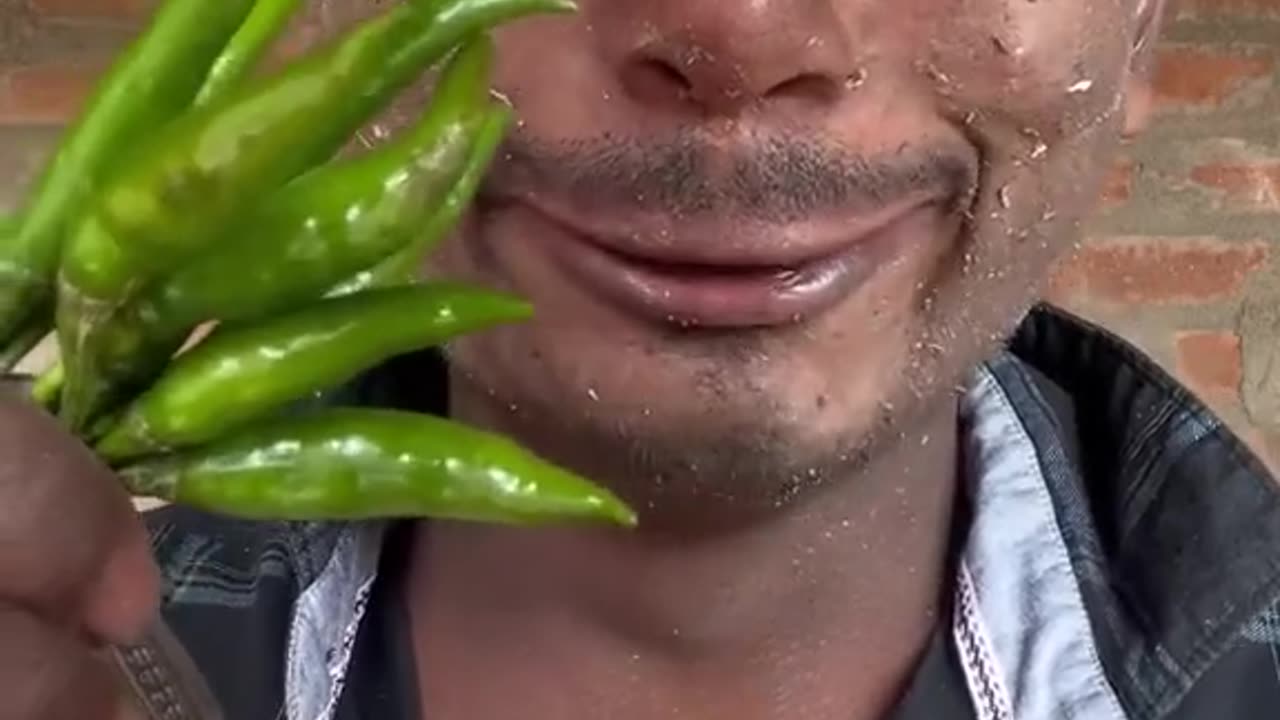 Poor boy eating mirchi