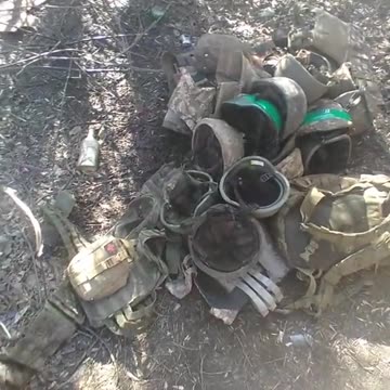 Ukrainians take inventory of helmets and vests scavenged off dead Ukrainian