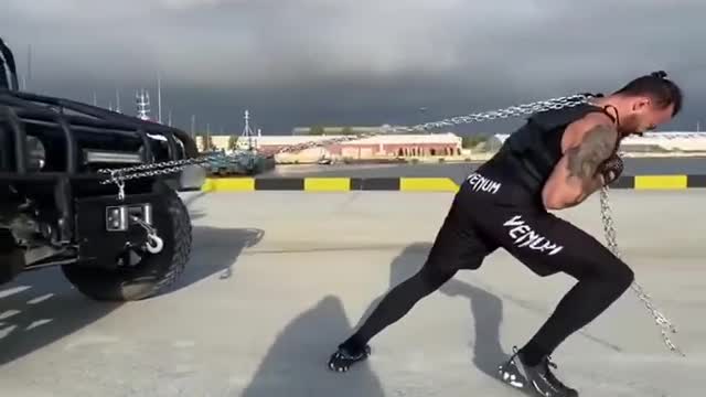 Man Pulls Jeep With Chain