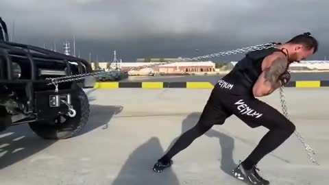 Man Pulls Jeep With Chain