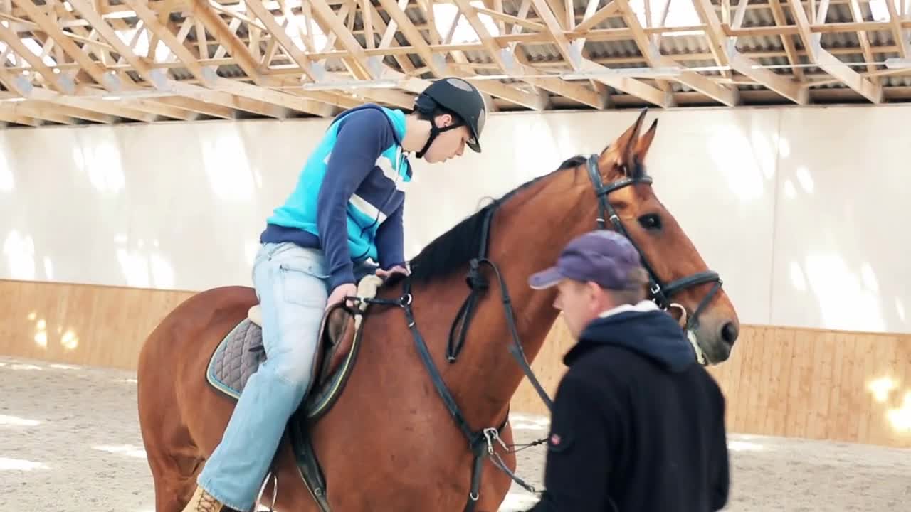 Young boy ride a horse on the riding lesson at the stable in Legnica