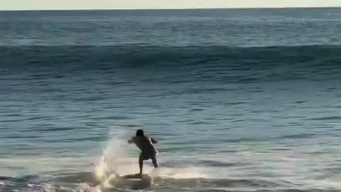 Expert surfer dancing with the waves