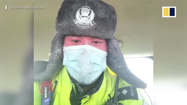 Police officer blown away by strong winds while helping stranded passengers in China