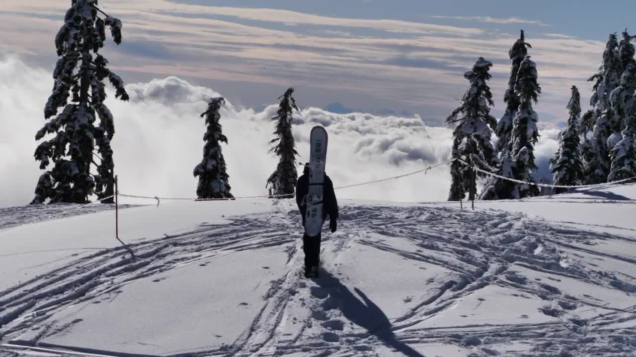 Skier at the peak of a snowy mountain