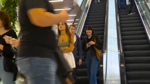 A very nice noughty girl on the escalator prank touching Hands On Escalator