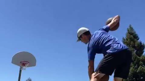 Guy Scores Two Consecutive Basketball Shots While Stablizing Himself Over Balancing Board