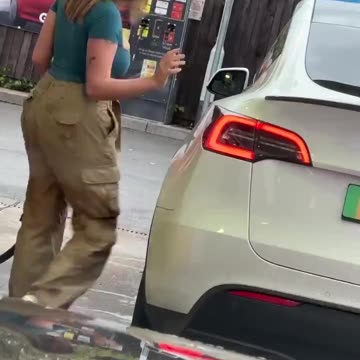 She is trying to put gas into an electric car
