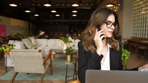 Businesswoman making a phone call in office