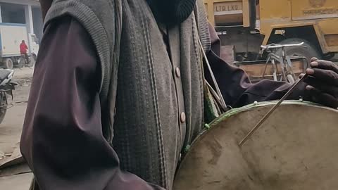 Old man playing Drum