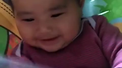 baby laughing over the baloon