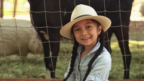 a child with a lot of joy takes a picture near his pets,