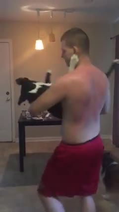 Owner slow dances with his dog in the kitchen
