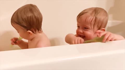 Watch Twins babies laughing while washing on bathroom