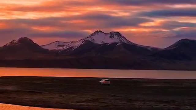 A mountain, a river, a moving car