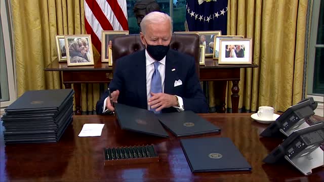 Barely on the job, Biden signs executive actions