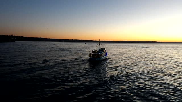 Boat sailing into the sunset on Christmas