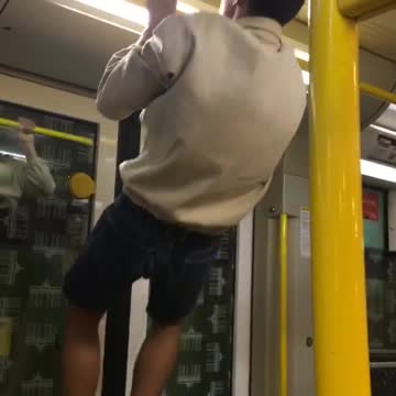 A guy does a pull up and hits head on bar